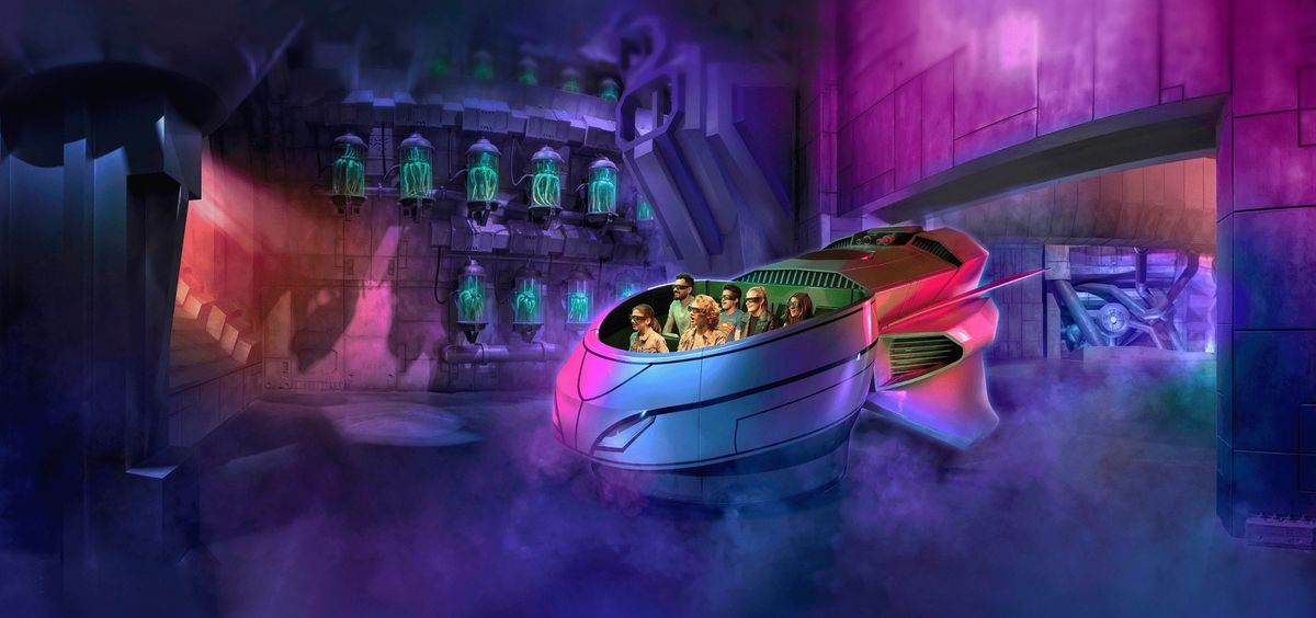 Futuristic theme park ride with passengers in a colorful, glowing, sci-fi environment at Warner Bros Abu Dhabi