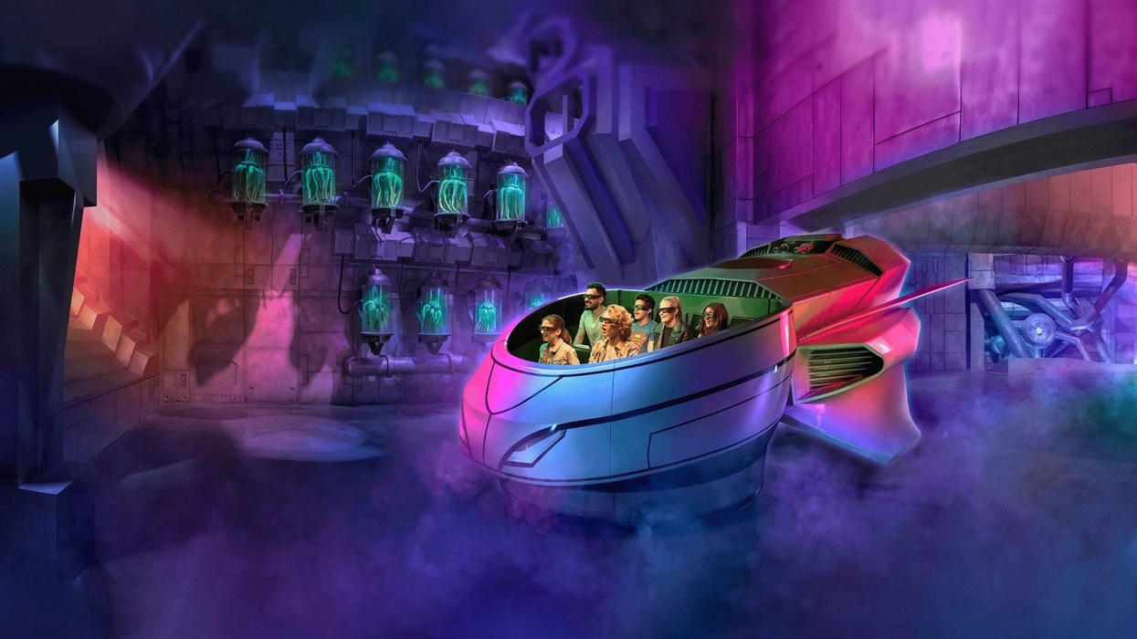 Futuristic theme park ride with passengers in a colorful, glowing, sci-fi environment at Warner Bros Abu Dhabi