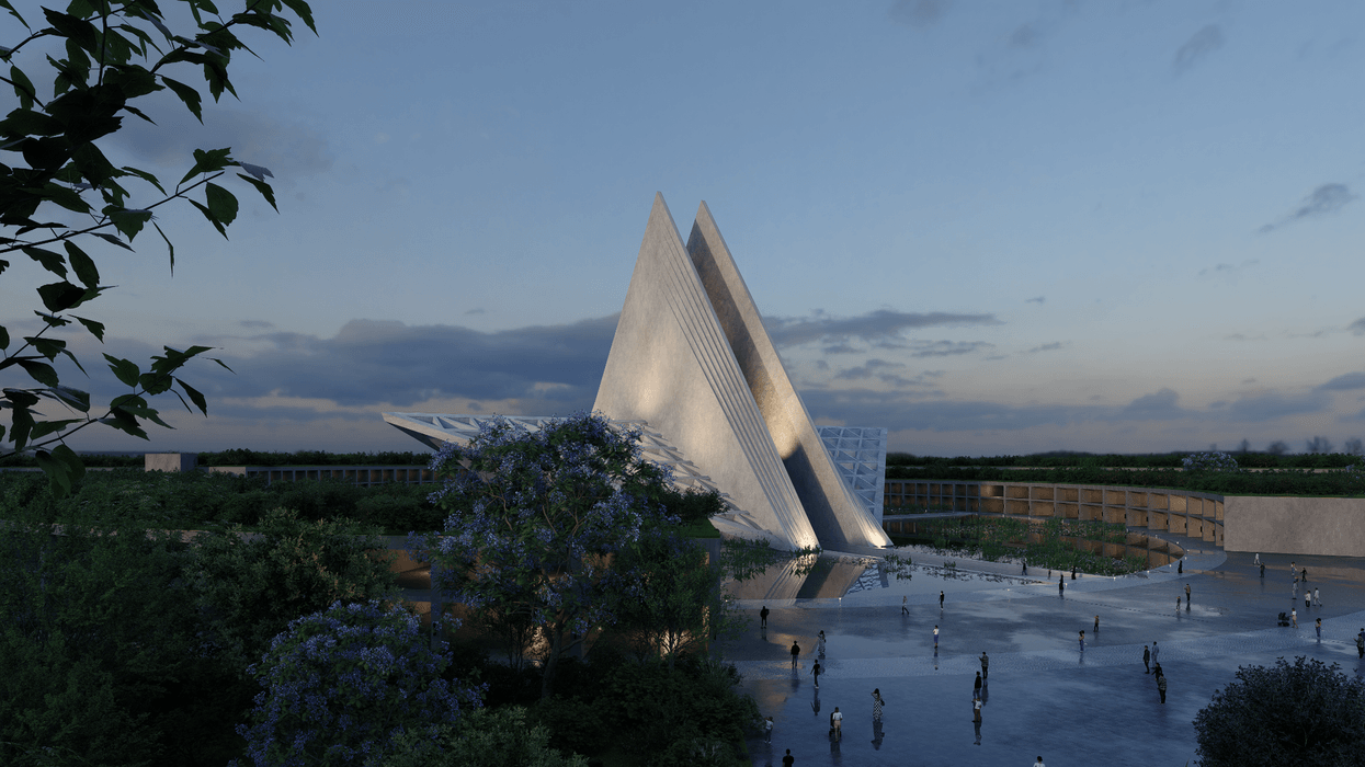 Futuristic triangular building called Mona Bangkok at dusk, surrounded by trees and people.