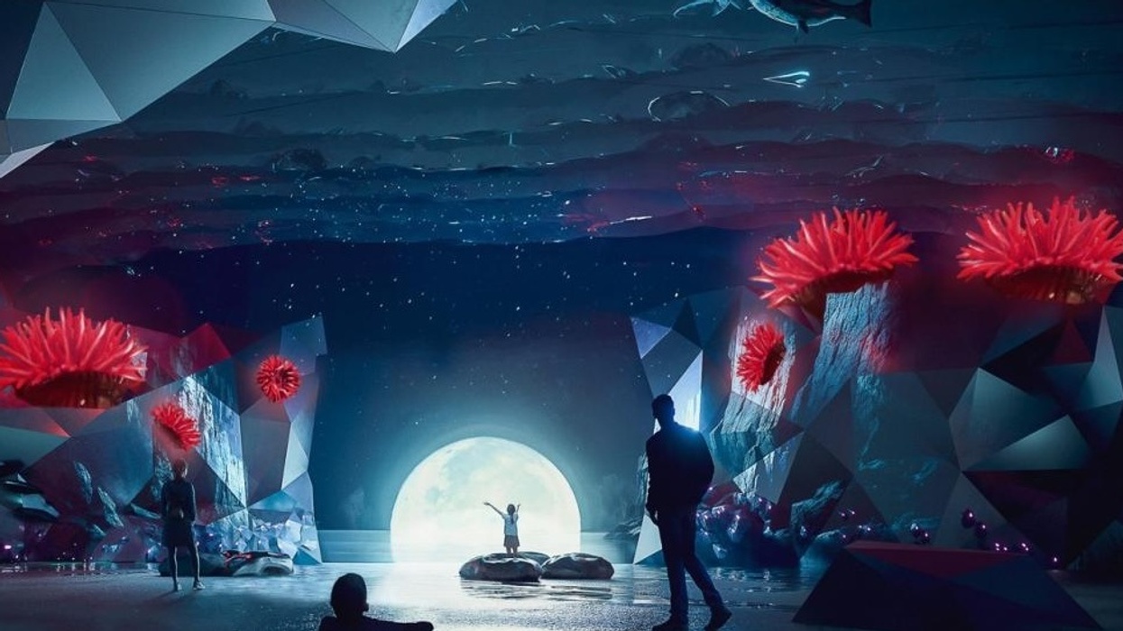 Futuristic zone at Eden Project Morecambe with glowing coral and people silhouetted against a large moon.