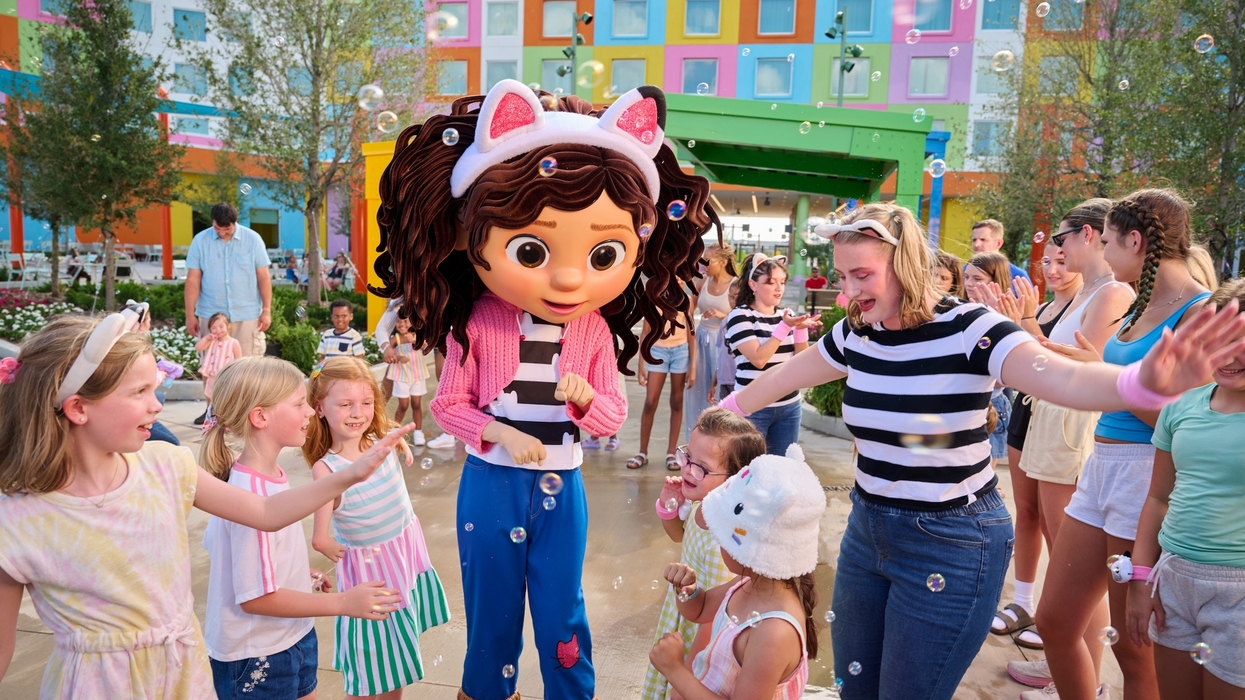 Gabby's Dollhouse mascot entertaining kids with bubbles in a colorful outdoor setting at Universal Kids Resort