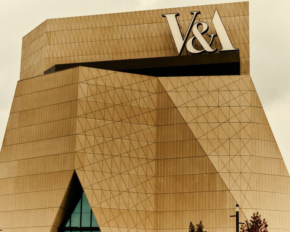 Geometric building facade with a large "V&A" sign on top. V&A East
