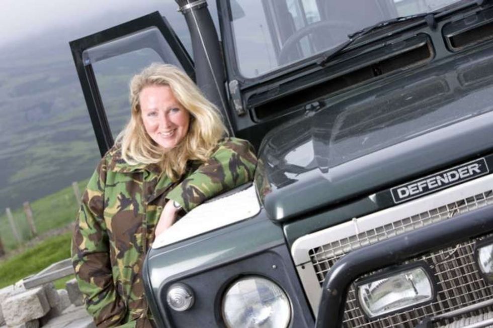 Ghillie Basan standing by Land Rover Defender