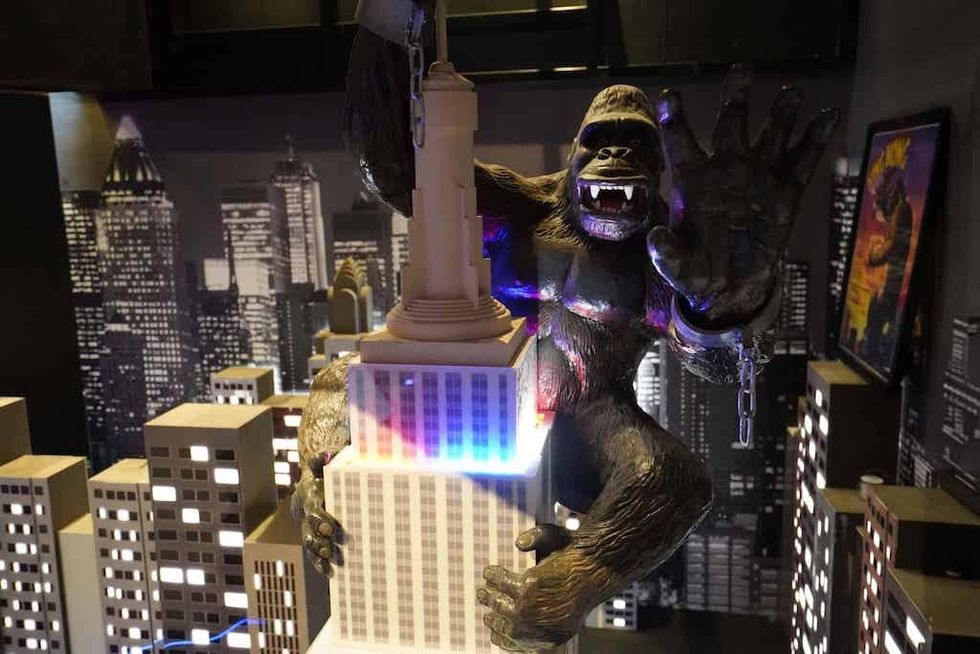 Giant gorilla figure climbing a skyscraper in a cityscape model at Albatross mini golf