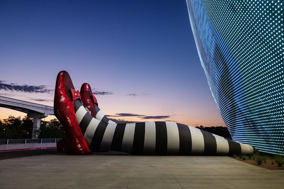 Giant striped legs and red shoes art installation at Sphere Las Vegas at sunset.
