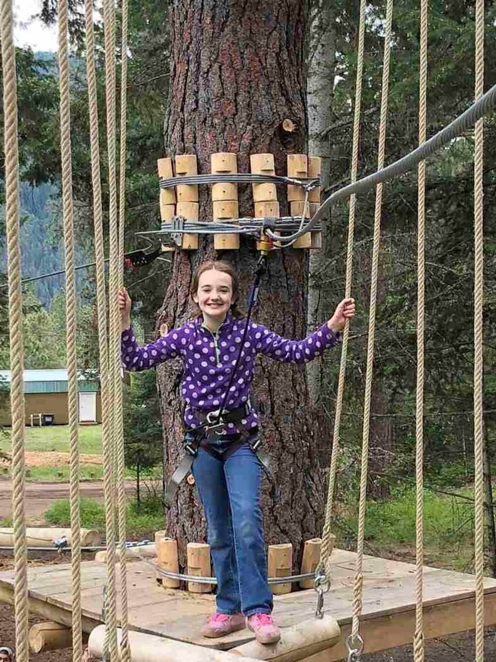 girl at tree to tree idaho in farragut state park
