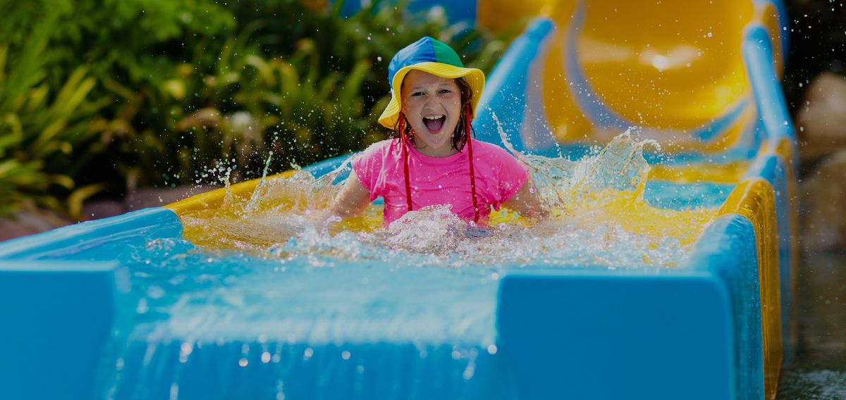 girl-laughing-on-water-slide