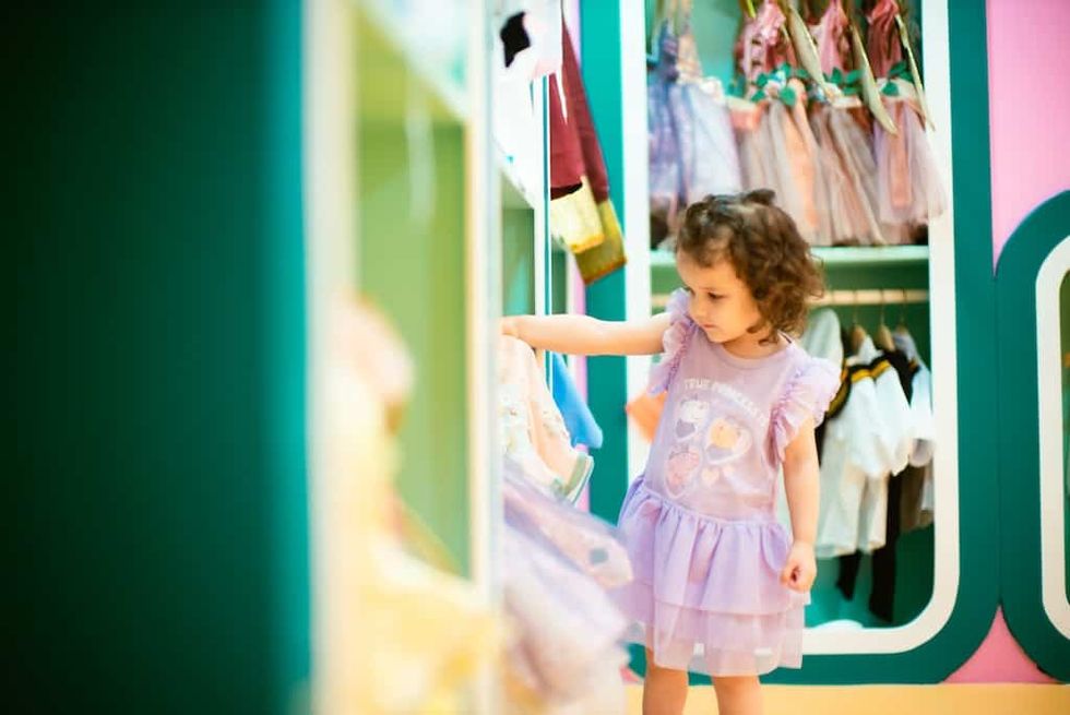 Girl looking at princess costumes