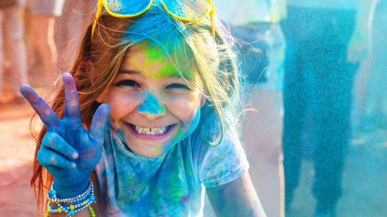 girl sprayed with paint at colour fun run pgav destinations