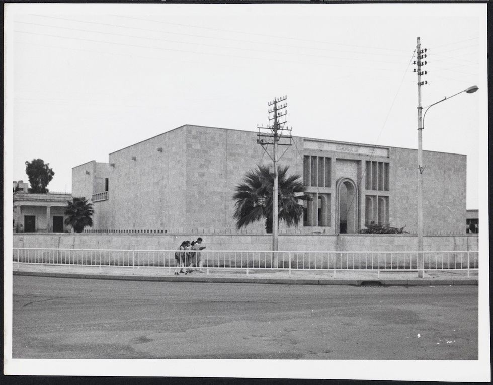 Girls walk alongside the completed Mosul Cultural Museum (Between 1970-72)