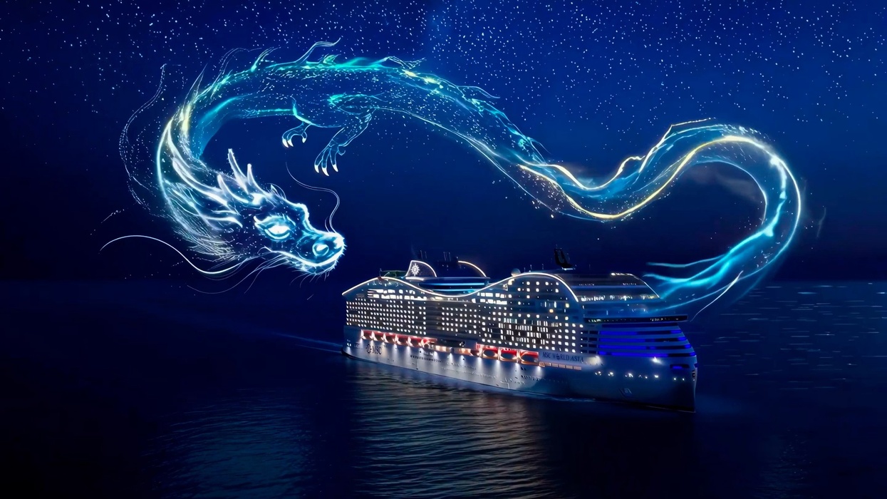 Glowing dragon flying over a cruise ship called MSC World Asia at night with a starry sky.