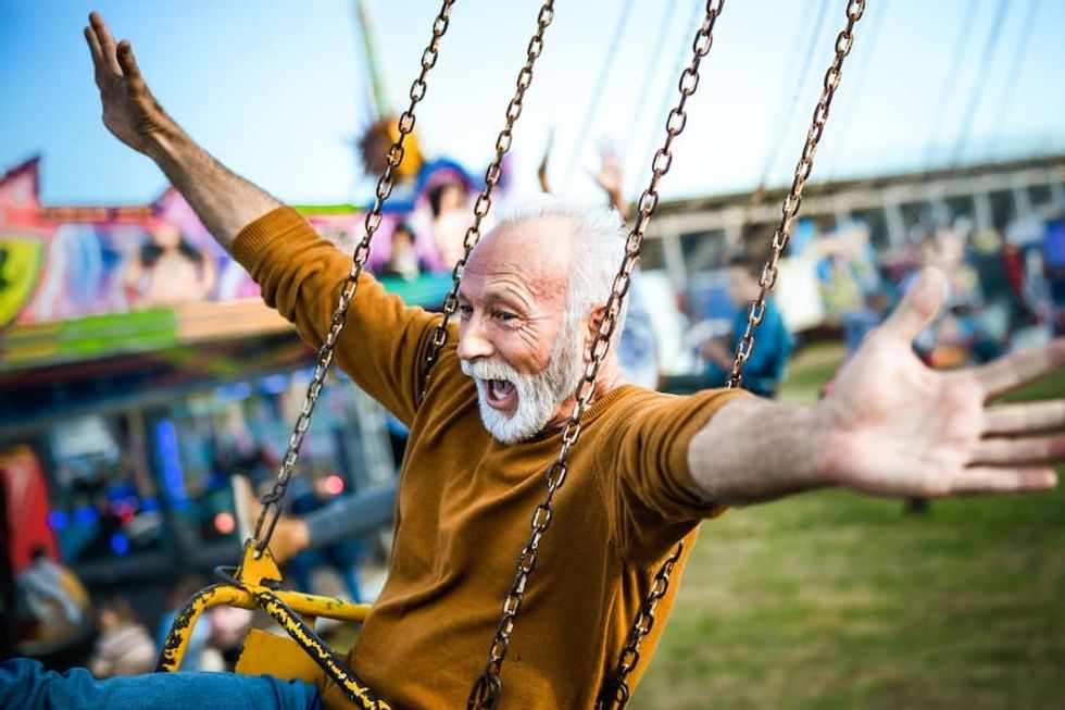 grandfather-on-ride-at-amusement-park