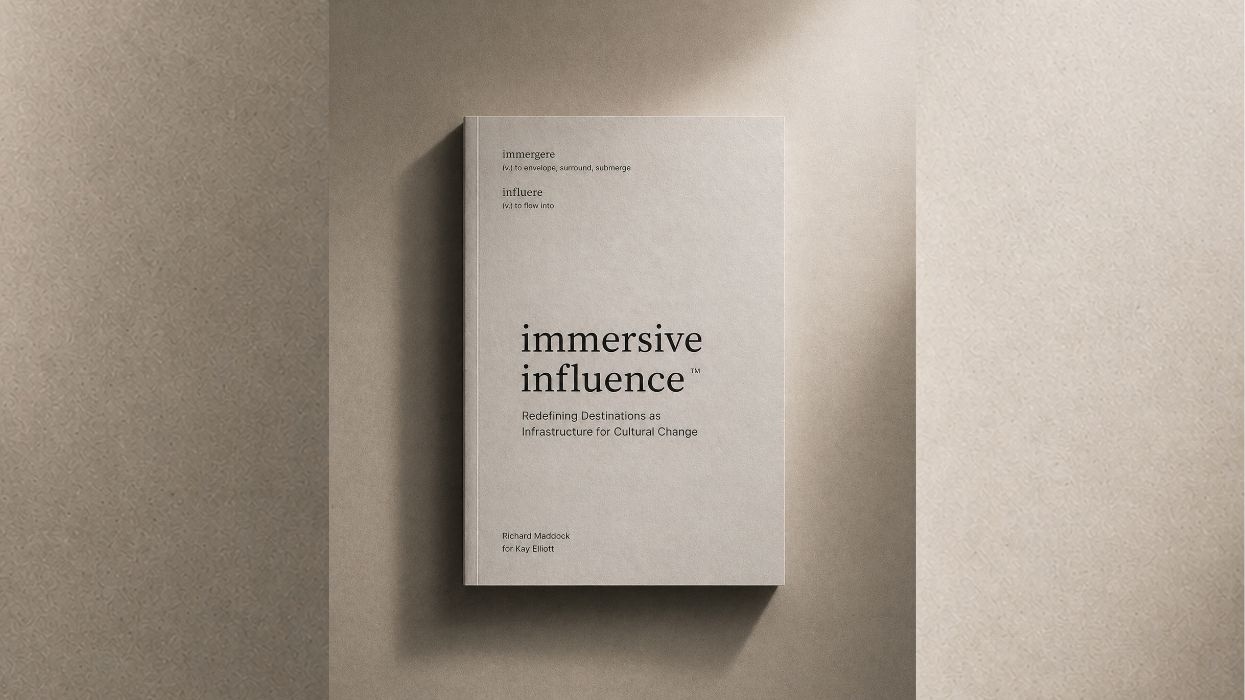 Gray book titled "Immersive Influence" on a textured surface.