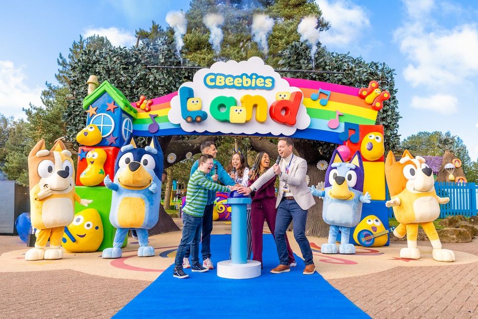 Group at CBeebies Land entrance with colorful characters and decorations.