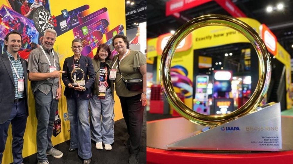 Group holding award beside close-up of "IAAPA Brass Ring" trophy at a colorful expo.