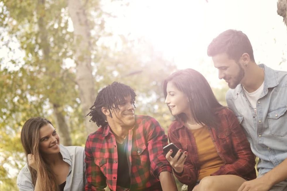 group of friends looking at phone