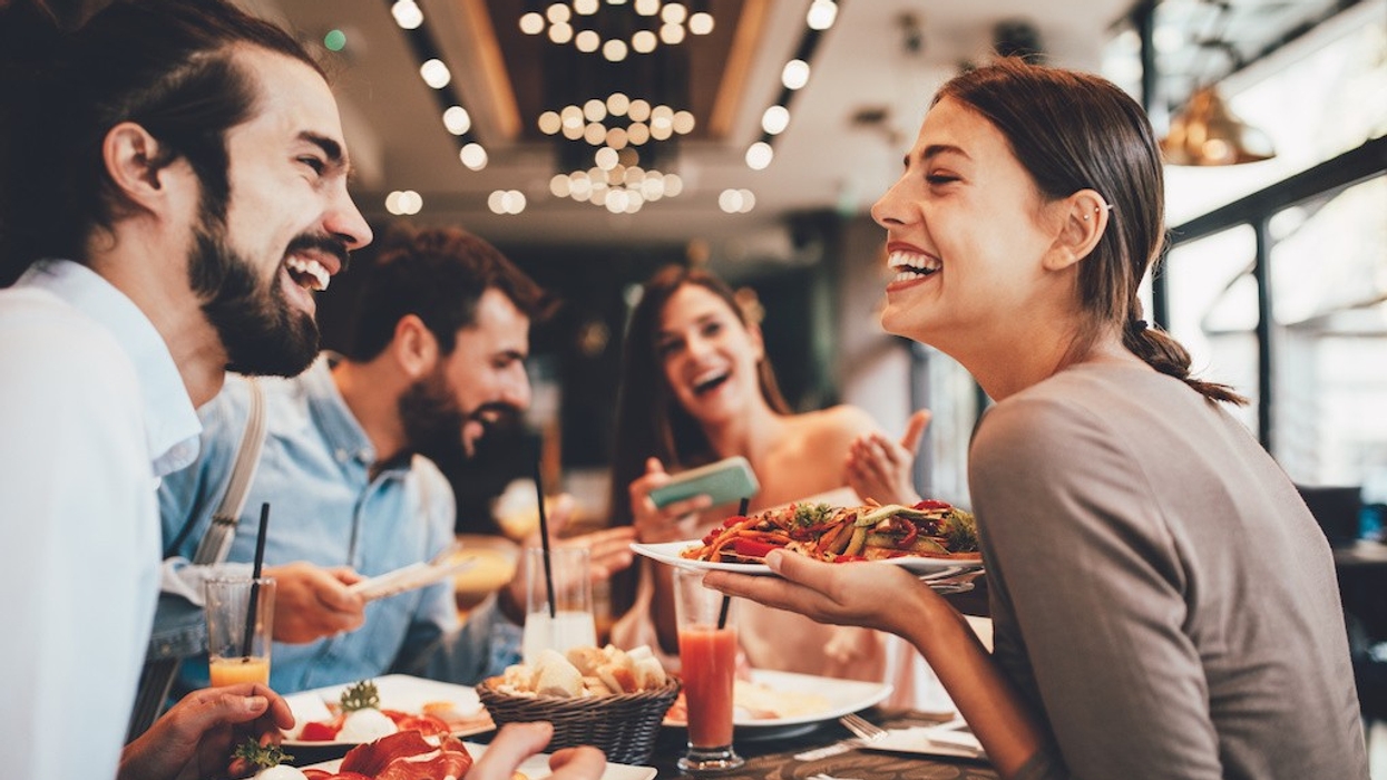 Group of Happy friends having breakfast in the restaurant