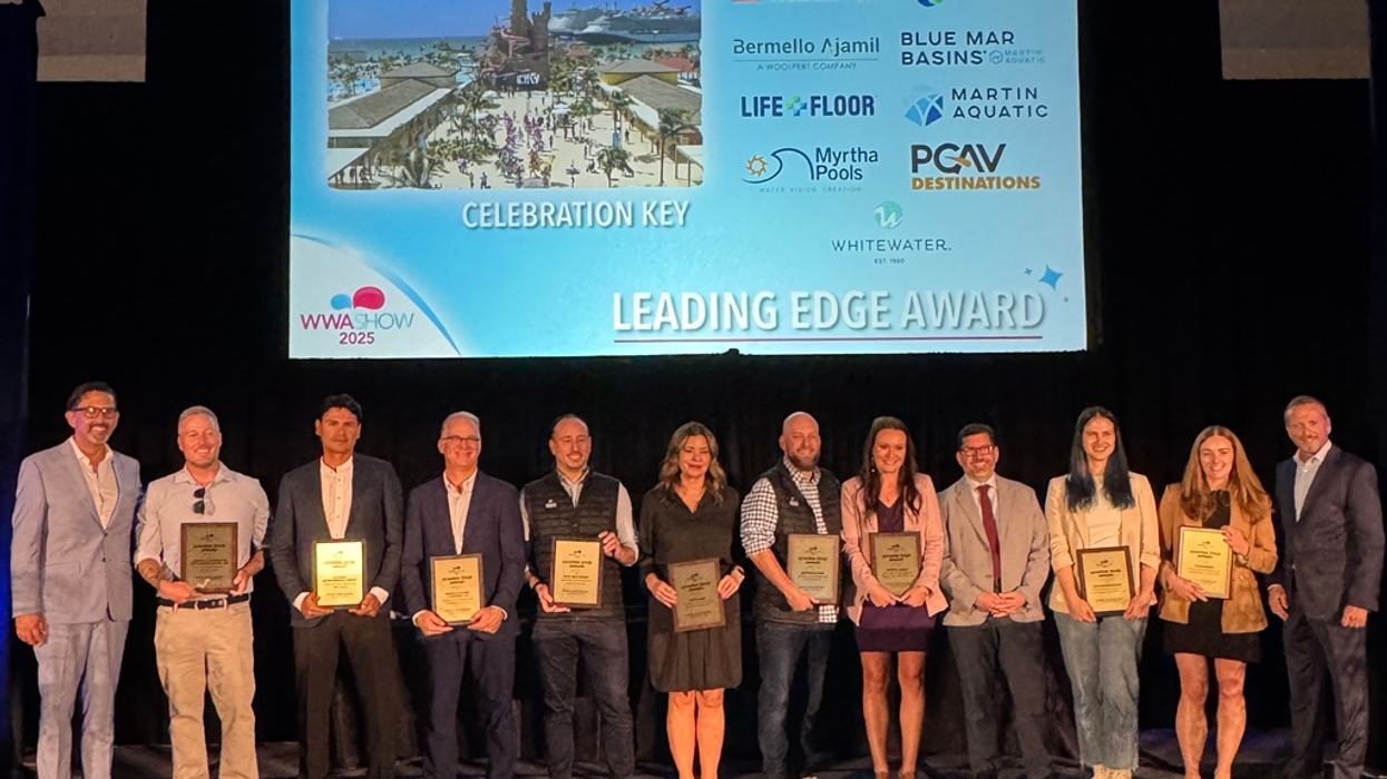 Group of people holding plaques on stage at the "Leading Edge Award" ceremony.