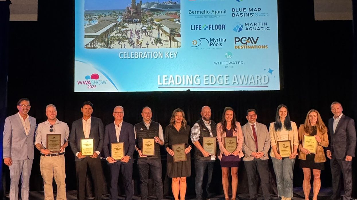 Group of people holding plaques on stage at the "Leading Edge Award" ceremony.