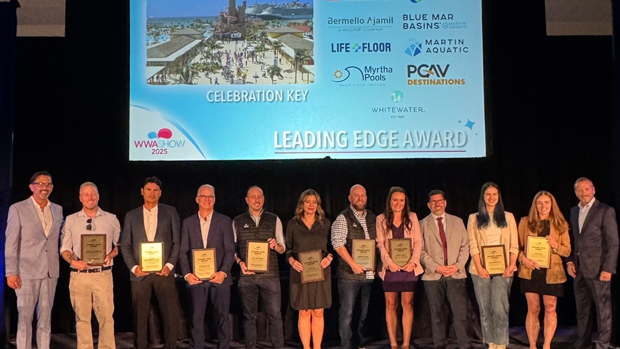 Group of people holding plaques on stage at the "Leading Edge Award" ceremony.