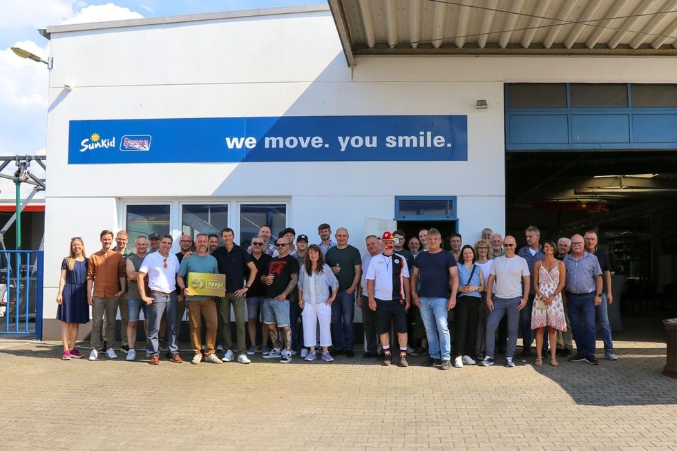 Group of people smiling outside a building with