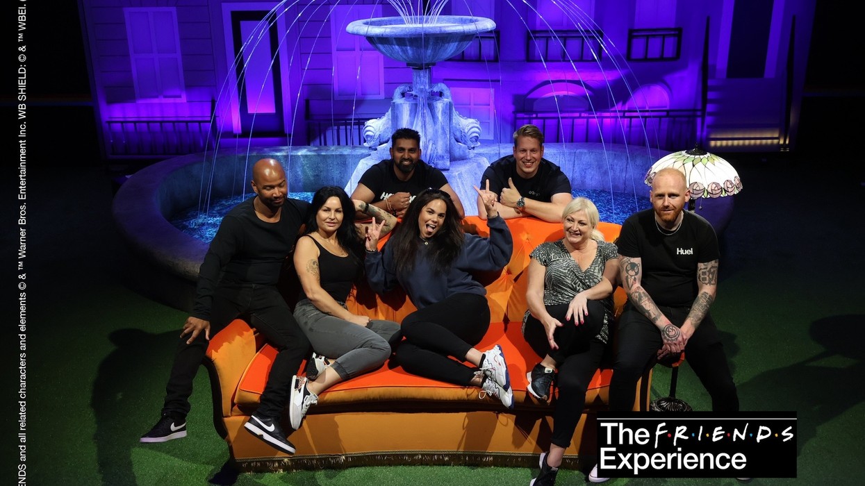 Group on the iconic "Friends" couch with fountain backdrop at "The Friends Experience".