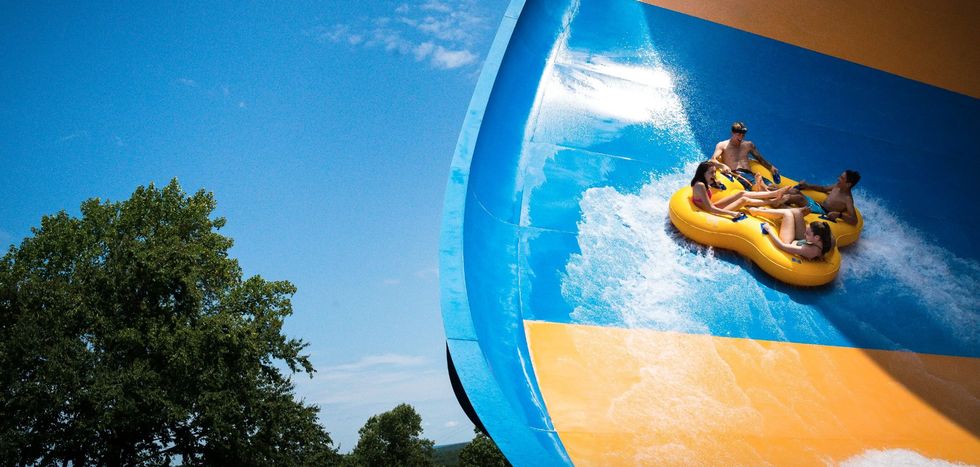 Group sliding on a large blue and yellow water slide at Camelbeach