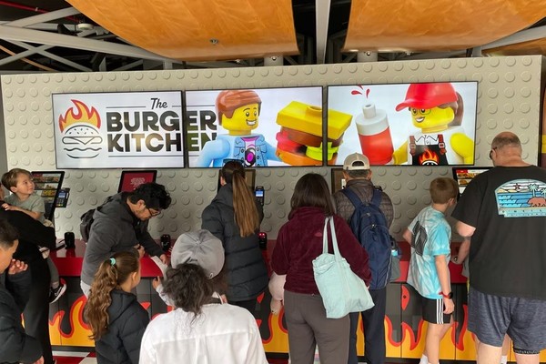 guests using self service kiosks at The Burger Kitchen at LEGOLAND California and Florida