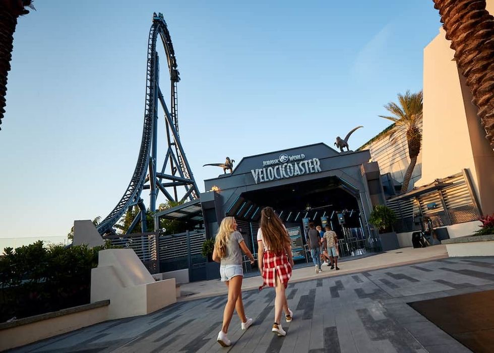 Guests walking into the VelociCoaster attraction at Islands of Adventure, Universal Studios Orlando.