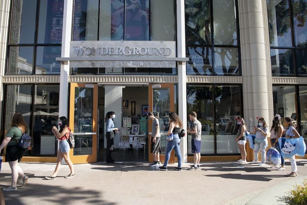 Guests wearing masks while visiting Downtown Disney District in Anaheim, California in July 2020.