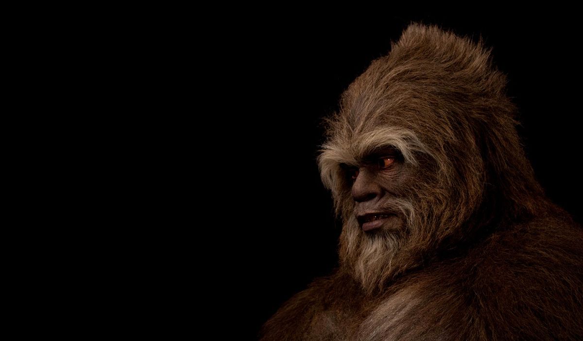 Hairy humanoid creature with glowing eyes in darkness.