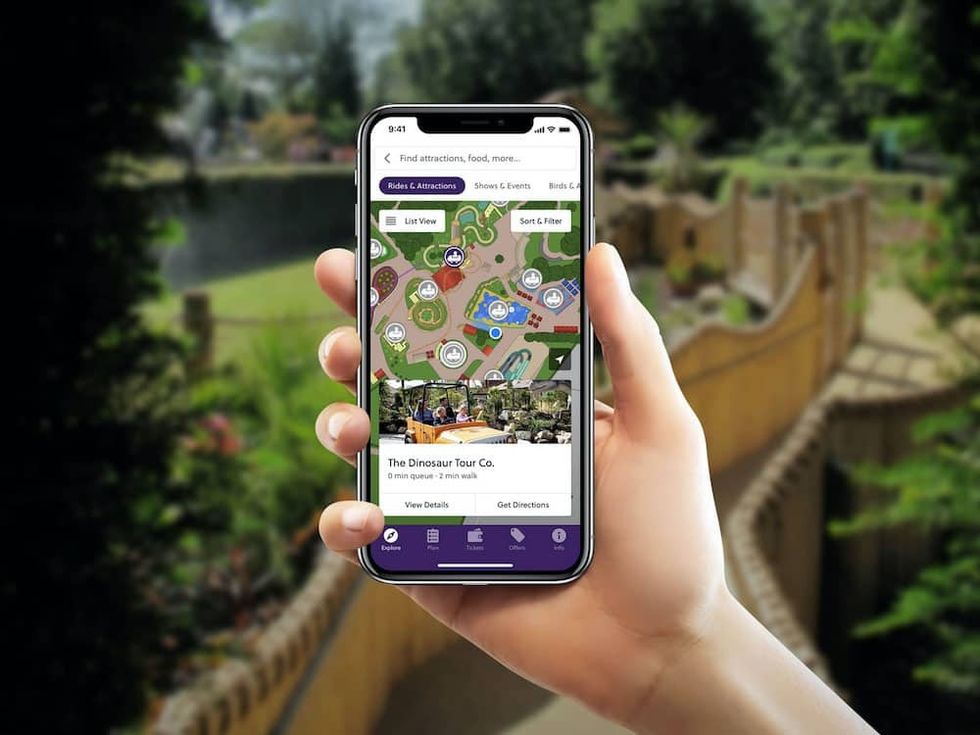 hand holding an attractions.io mobile app Guest experience COVID 19