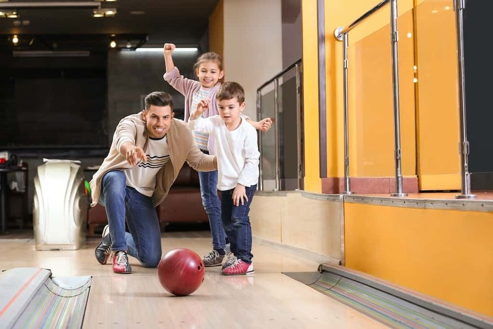 Happy family spending time together in bowling club