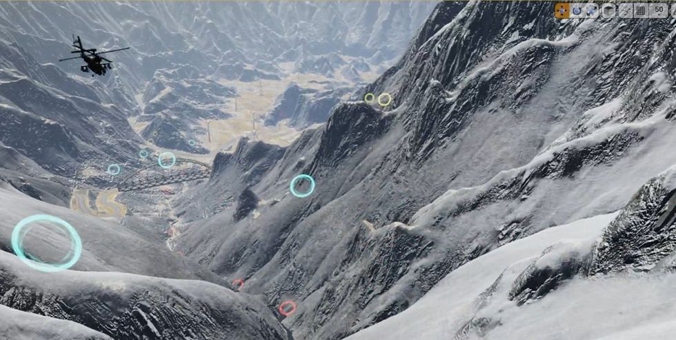 Helicopter flying over snow-covered mountains with colorful rings in the air.