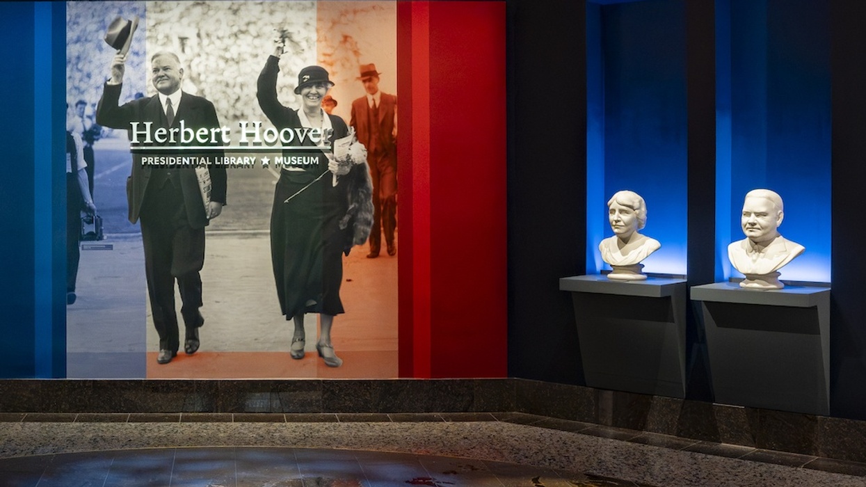 Herbert Hoover display with presidential portrait and two busts in a museum setting.