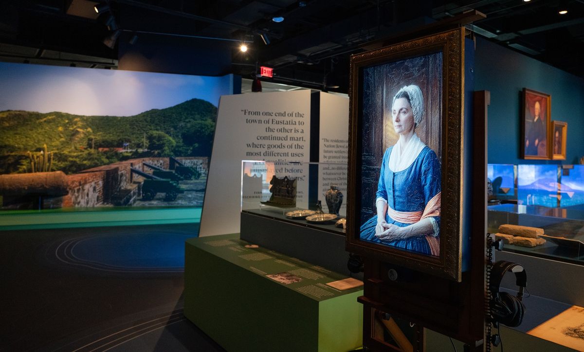 Historical museum exhibit with portraits and artefacts displayed at The Weitzman Museum