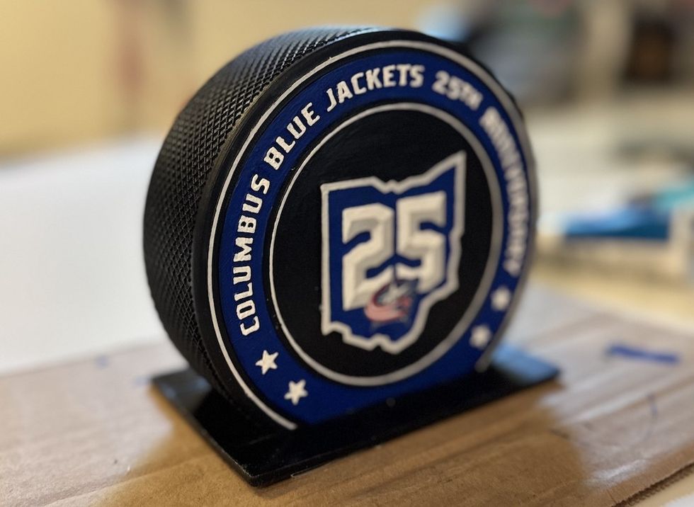 Hockey puck with "Columbus Blue Jackets 25th Anniversary" logo.