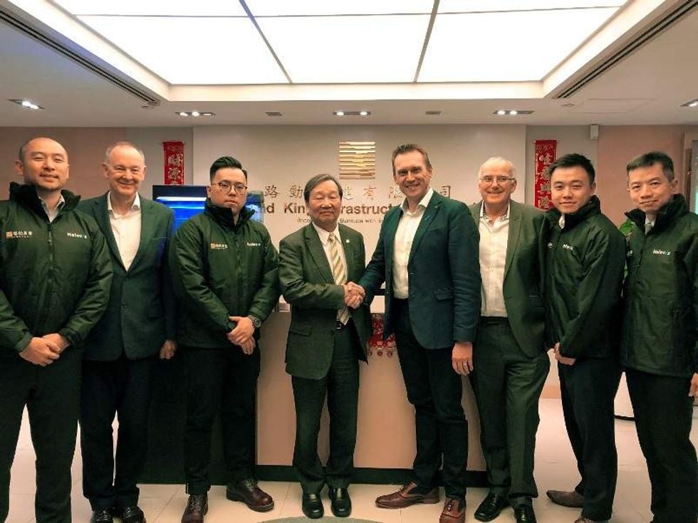 holovis and road king staff shake hands in celebration of new investment