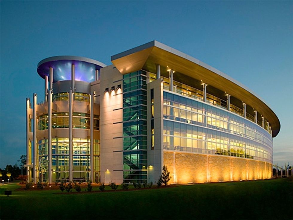 Hubbell Lighting Headquarters, a modern glass building at dusk with lit windows and curved roof.