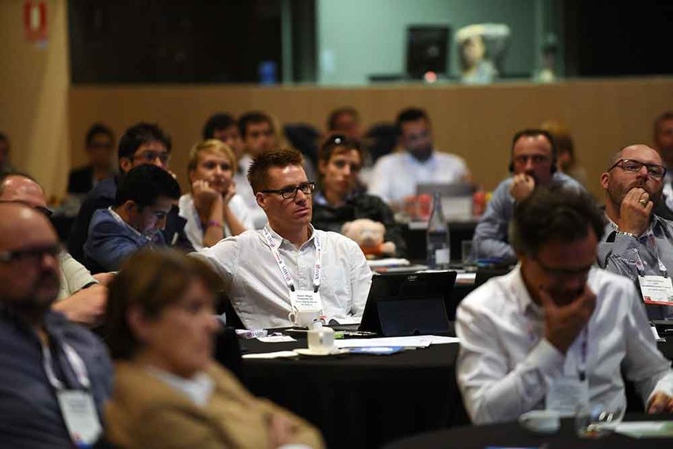 IAAPA EAS conference meeting man sat in white shirt with glasses in a group
