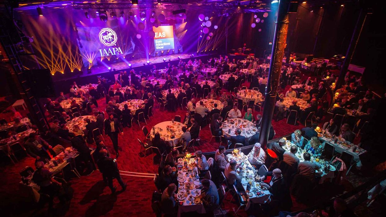 IAAPA EAS showroom presentation tables chairs people purple blue lighting final tickets