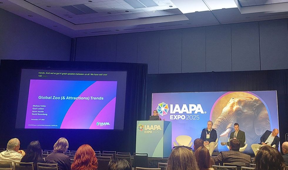 IAAPA Expo 2025 presentation on global zoo trends with speakers on stage and audience seated.