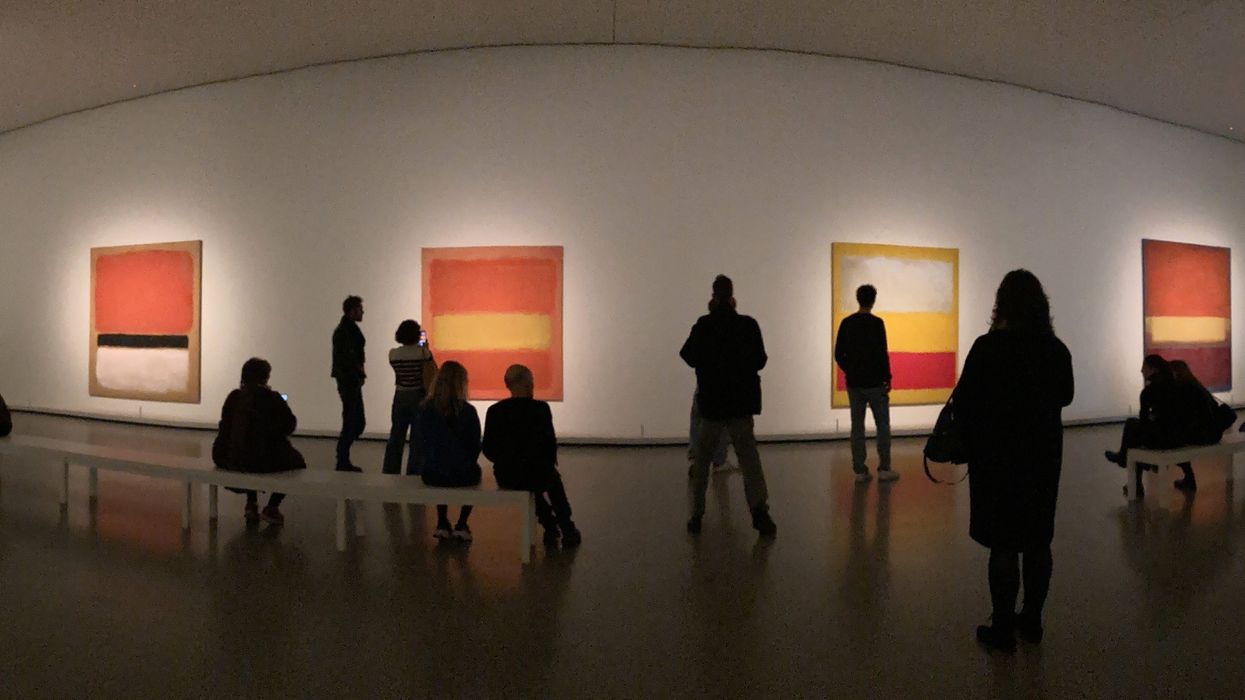ICOM UK. Silhouettes of people in a gallery, stood in front of a wall of art
