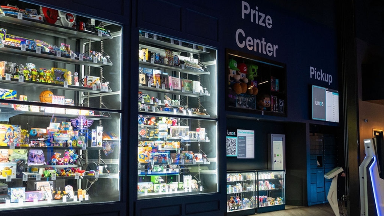 Illuminated arcade prize centre at Lumos, with shelves of toys and collectibles.
