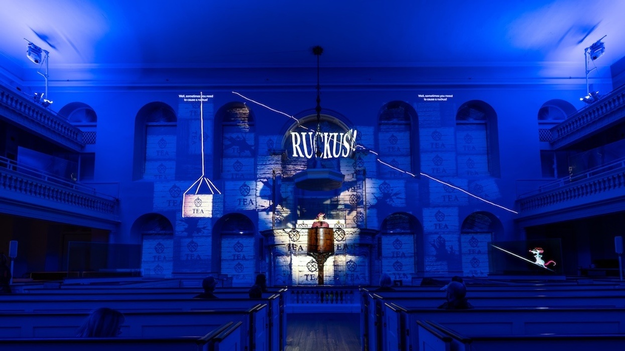 Illuminated church interior with blue lighting and "Ruckus" in bold white letters.