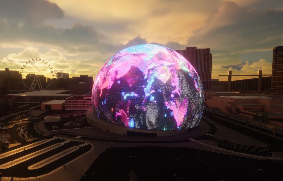 Illuminated globe-shaped building called Sphere in cityscape at sunset, with Ferris wheel in background.