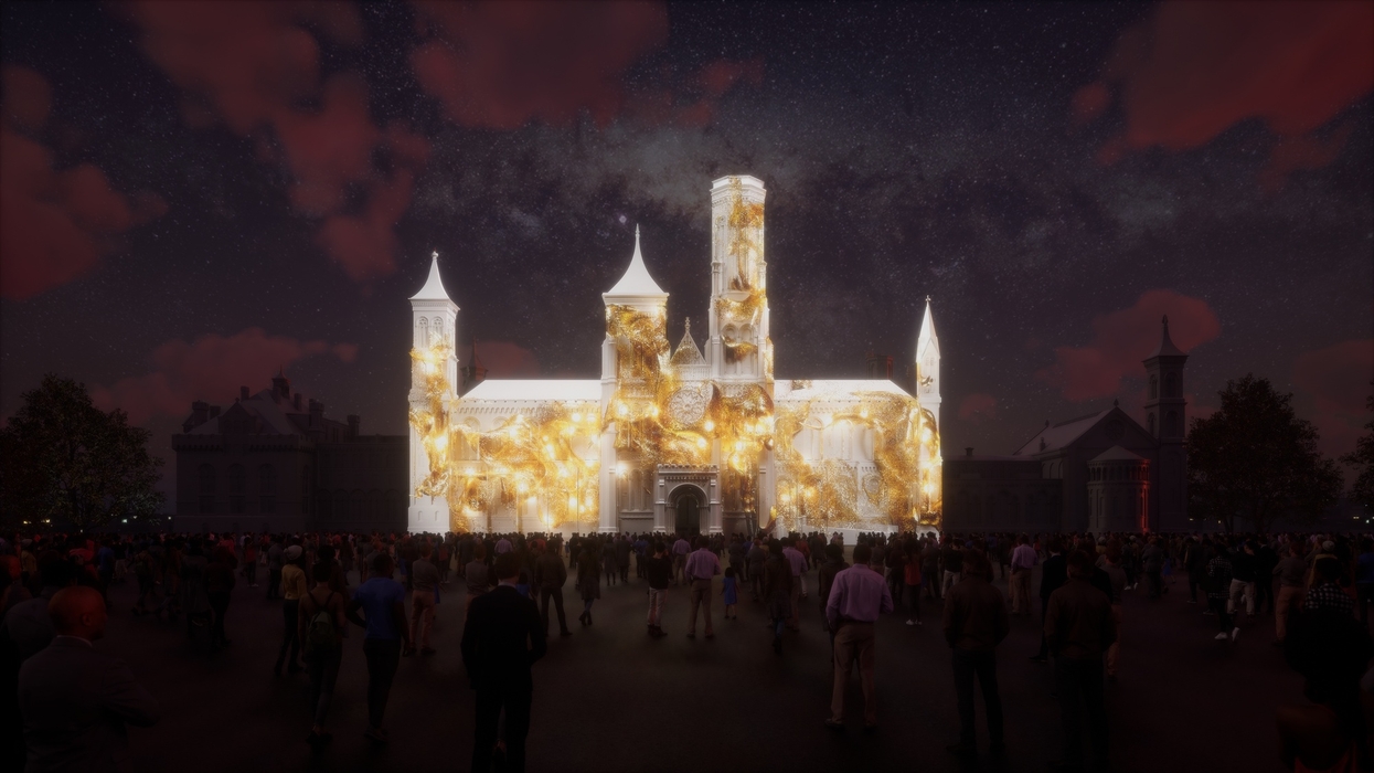Illuminated Smithsonian Castle with crowd at night sky backdrop.