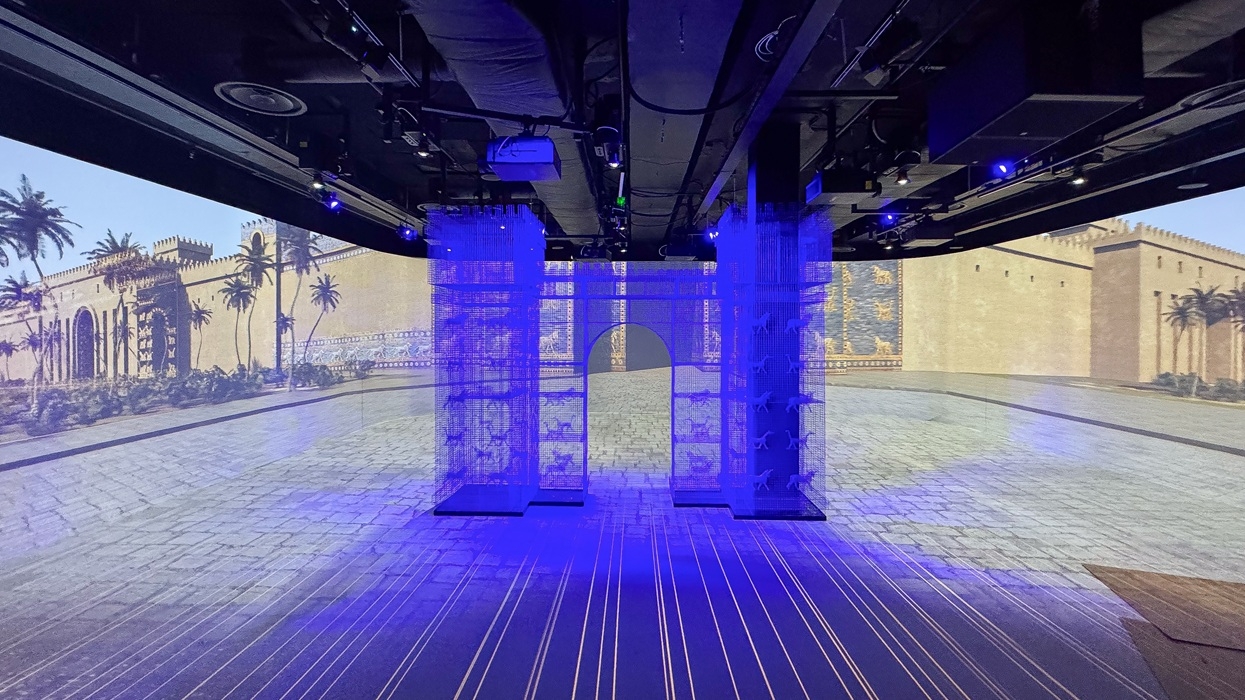 Illuminated virtual cityscape display with columns and ancient architectural backdrop at the Timewalk exhibition.