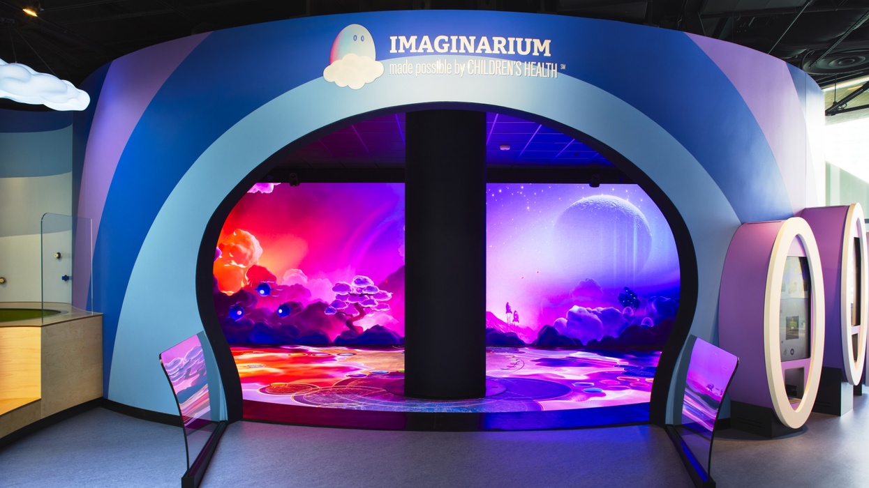 Imaginarium entrance with vibrant, colorful cosmic display and curved blue wall.