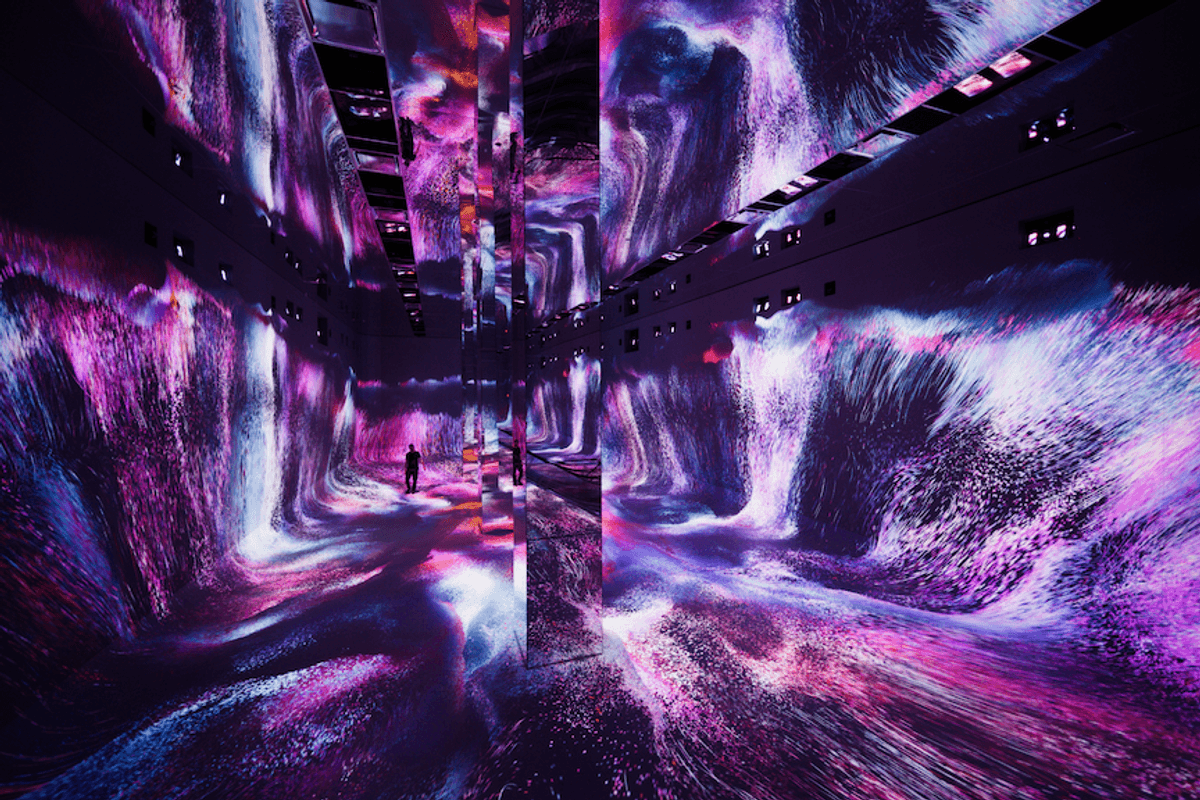 Immersive room with vibrant pink and purple digital waves and mirrored reflections.